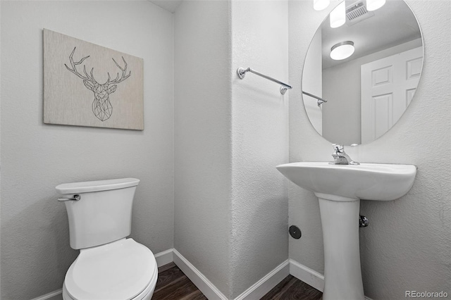 10010 E Gunnison Pl Unit 707, Aurora, CO 80247 - bathroom featuring wood finished floors, toilet, and baseboards