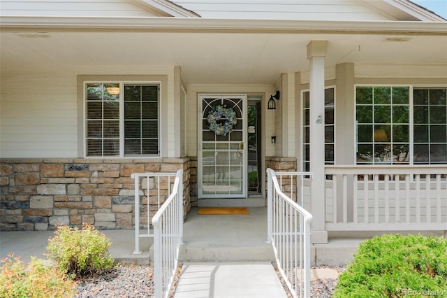10877 W 55th Ln, Arvada, CO 80002 - entrance to property featuring covered porch and stone siding