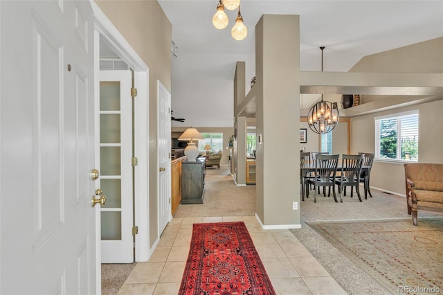 10877 W 55th Ln, Arvada, CO 80002 - carpeted entryway with a chandelier, tile patterned flooring, and baseboards