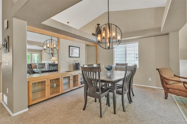 10877 W 55th Ln, Arvada, CO 80002 - carpeted dining room with a chandelier, a tray ceiling, and baseboards