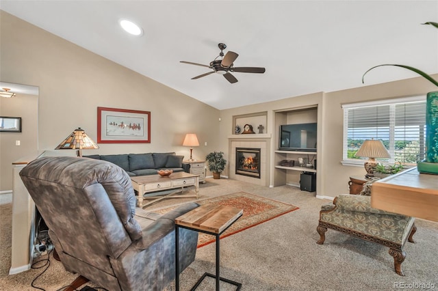 10877 W 55th Ln, Arvada, CO 80002 - carpeted living room featuring ceiling fan, vaulted ceiling, built in shelves, baseboards, and a tile fireplace