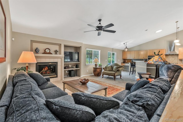 10877 W 55th Ln, Arvada, CO 80002 - living room with a ceiling fan, lofted ceiling, light carpet, a tile fireplace, and baseboards