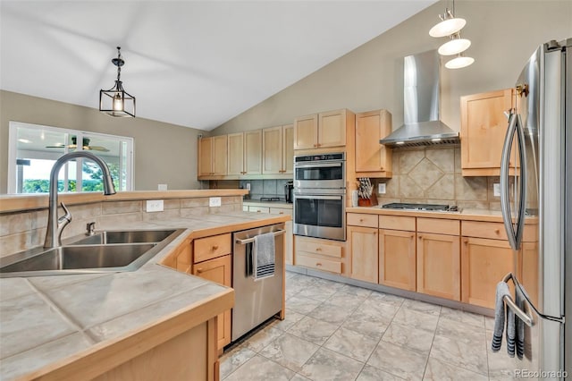 10877 W 55th Ln, Arvada, CO 80002 - kitchen with stainless steel appliances, a sink, light brown cabinets, wall chimney range hood, and lofted ceiling
