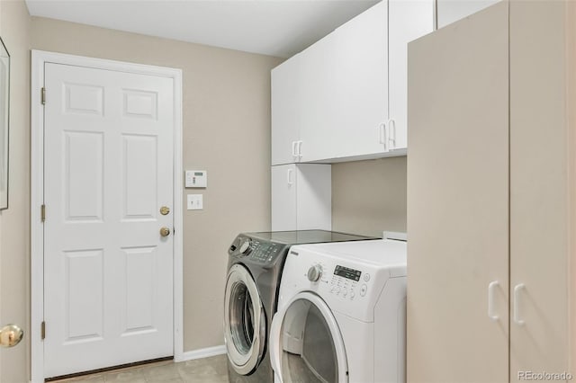 10877 W 55th Ln, Arvada, CO 80002 - laundry area featuring washer and clothes dryer, cabinet space, baseboards, and light tile patterned flooring