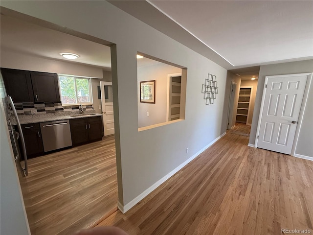 8307 E 14th Ave, Denver, CO 80220 - corridor featuring light wood-style floors, baseboards, and a sink