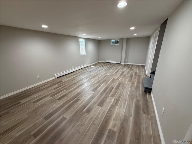 8307 E 14th Ave, Denver, CO 80220 - basement with a baseboard heating unit, wood finished floors, baseboards, and recessed lighting