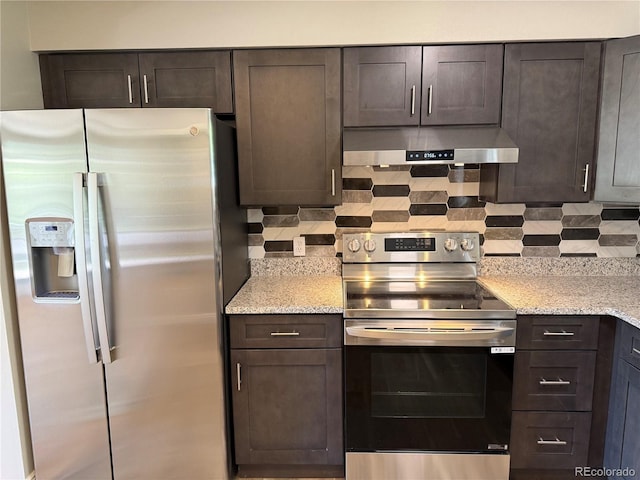 8307 E 14th Ave, Denver, CO 80220 - kitchen with appliances with stainless steel finishes, wall chimney range hood, dark brown cabinetry, and light stone countertops