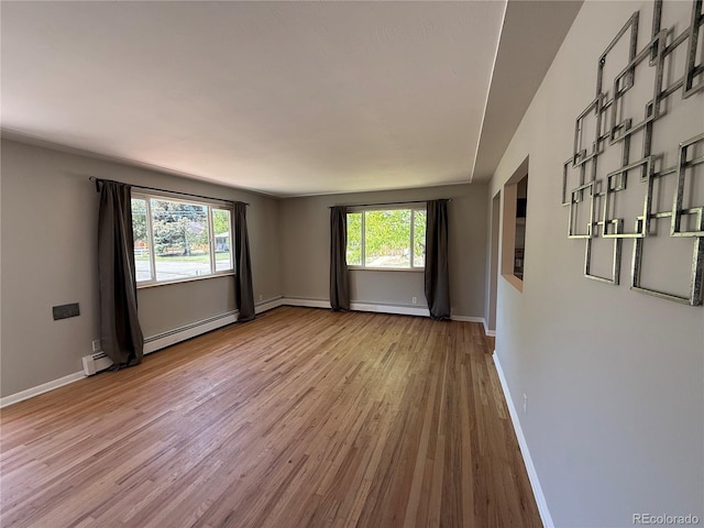 8307 E 14th Ave, Denver, CO 80220 - unfurnished room with wood finished floors, baseboards, and a baseboard heating unit