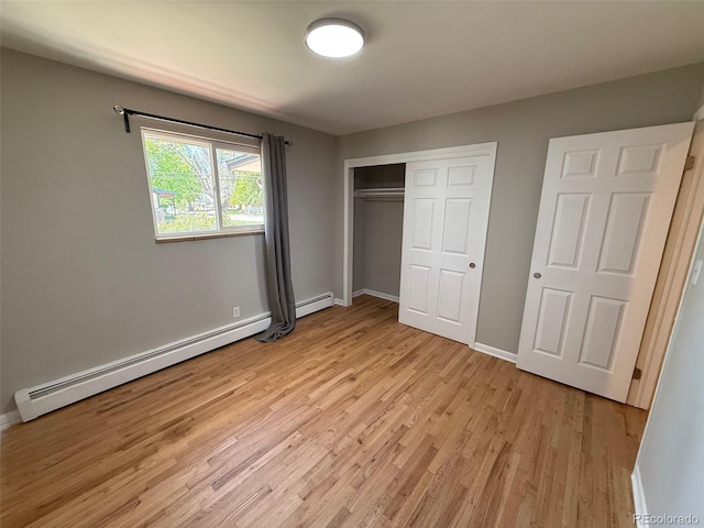 8307 E 14th Ave, Denver, CO 80220 - unfurnished bedroom with light wood-style floors, baseboards, a closet, and baseboard heating