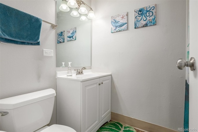 bathroom with toilet and vanity