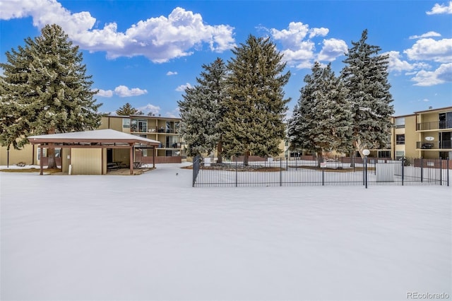 yard layered in snow with fence