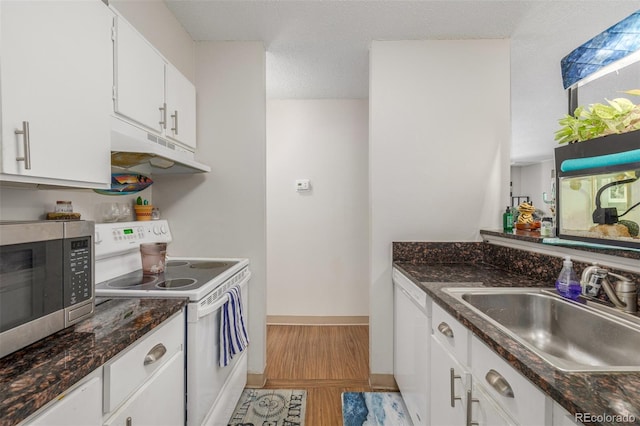 2281 S Vaughn Way Unit 316A, Aurora, CO 80014 - kitchen featuring white appliances, under cabinet range hood, white cabinets, dark stone counters, and light wood-style floors