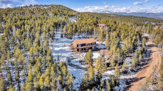 birds eye view of property with a mountain view and a view of trees