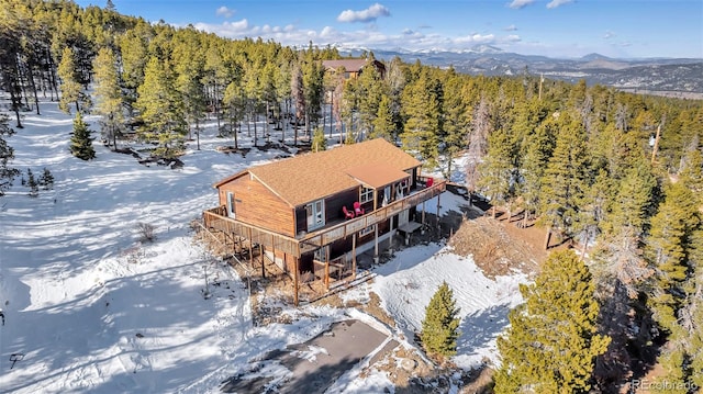 drone / aerial view with a forest view and a mountain view