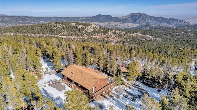 drone / aerial view featuring a mountain view and a wooded view