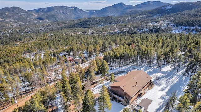 drone / aerial view with a mountain view and a view of trees