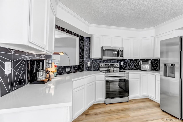 kitchen with light wood-style floors, appliances with stainless steel finishes, white cabinets, and light countertops