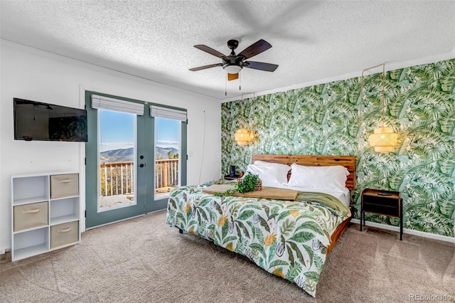 carpeted bedroom with french doors, a textured ceiling, access to outside, and wallpapered walls