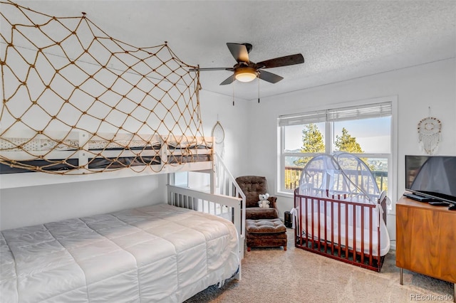 bedroom featuring a textured ceiling and carpet flooring