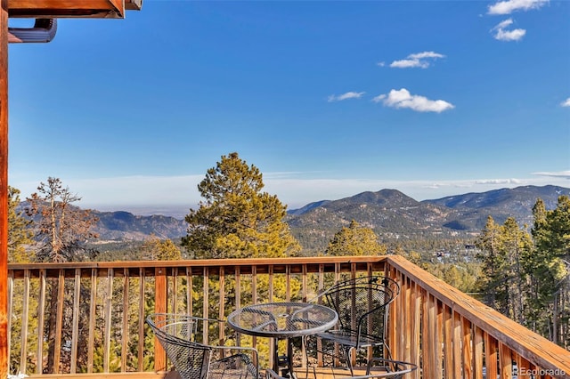 balcony with a deck with mountain view and outdoor dining area