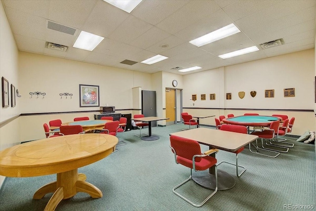 rec room with a paneled ceiling and carpet flooring