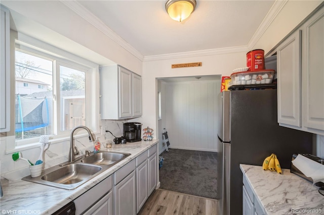 2080 E 84th Ave, Denver, CO 80229 - kitchen featuring a sink, light wood-style flooring, gray cabinets, and ornamental molding