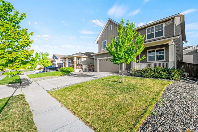 3074 Kestrel St, Brighton, CO 80601 - view of front of house with a porch, board and batten siding, a garage, and concrete driveway
