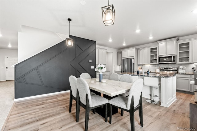 3074 Kestrel St, Brighton, CO 80601 - dining space featuring light wood finished floors and recessed lighting