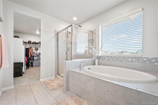 3074 Kestrel St, Brighton, CO 80601 - bathroom with a garden tub, a shower stall, a walk in closet, and tile patterned flooring