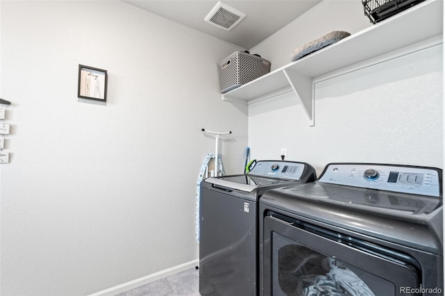 3074 Kestrel St, Brighton, CO 80601 - laundry area with washer and clothes dryer and light tile patterned floors