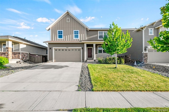 3074 Kestrel St, Brighton, CO 80601 - view of front of home featuring board and batten siding, a garage, driveway, and covered porch