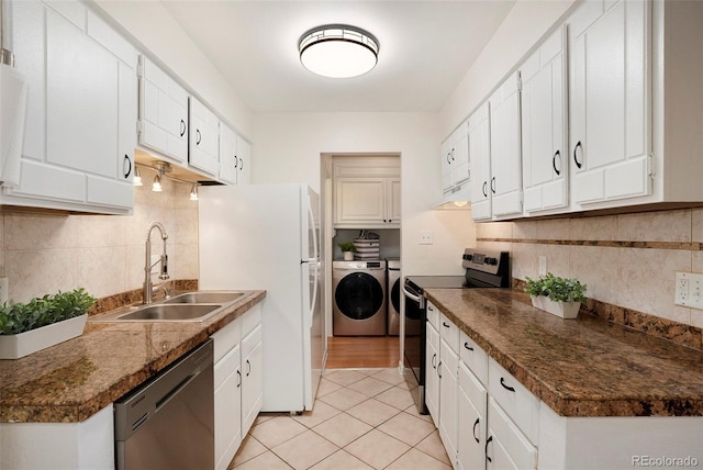 kitchen featuring electric range, a sink, white cabinets, dishwashing machine, and washing machine and dryer