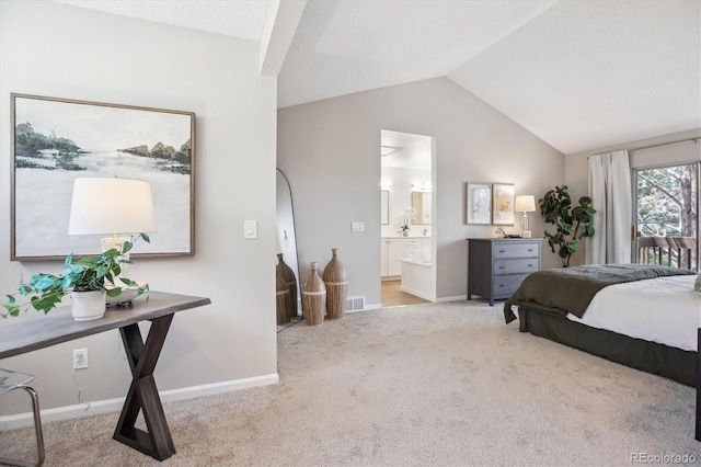 bedroom featuring carpet floors, baseboards, lofted ceiling, and connected bathroom