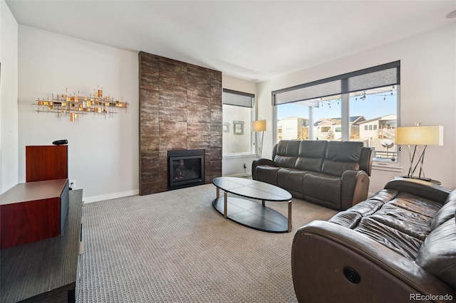 living room with light colored carpet and a tiled fireplace