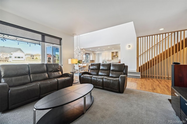 living room with hardwood / wood-style flooring and a notable chandelier