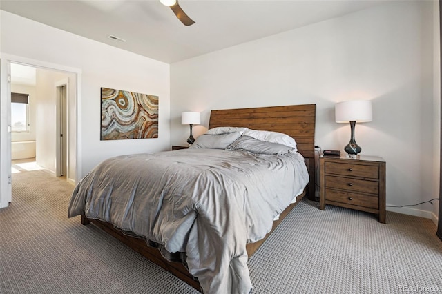 carpeted bedroom featuring ceiling fan and ensuite bathroom