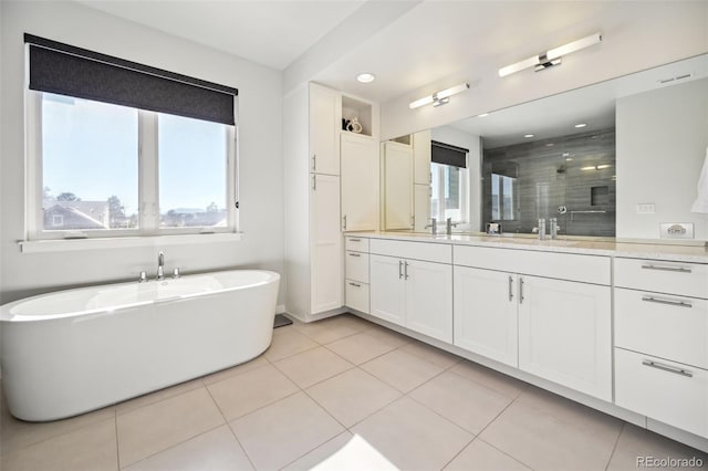 bathroom featuring tile patterned flooring, shower with separate bathtub, and vanity