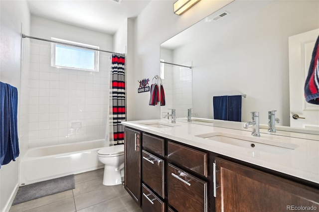 full bathroom with tile patterned flooring, shower / bath combination with curtain, vanity, and toilet