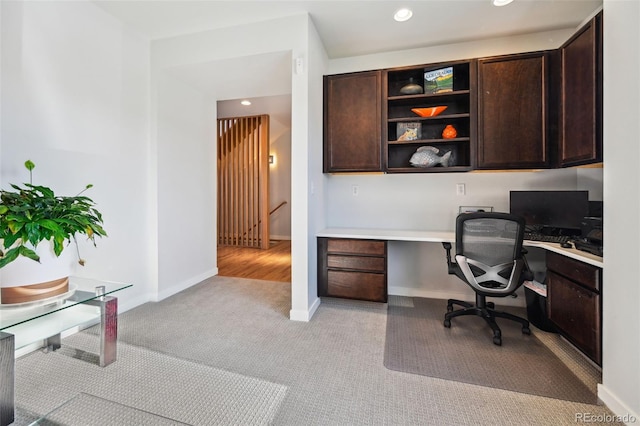 carpeted home office with built in desk