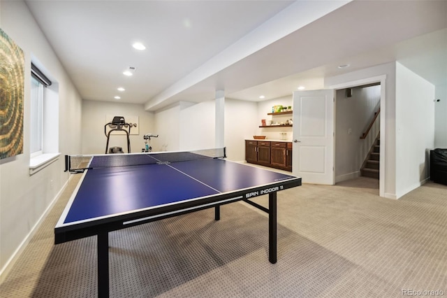 recreation room with light colored carpet