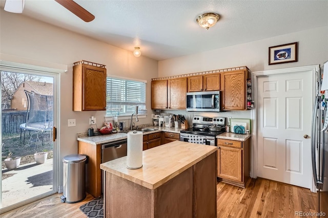 9615 Lansing Cir, Commerce City, CO 80022 - kitchen with a ceiling fan, a sink, wood counters, light wood-style flooring, and appliances with stainless steel finishes