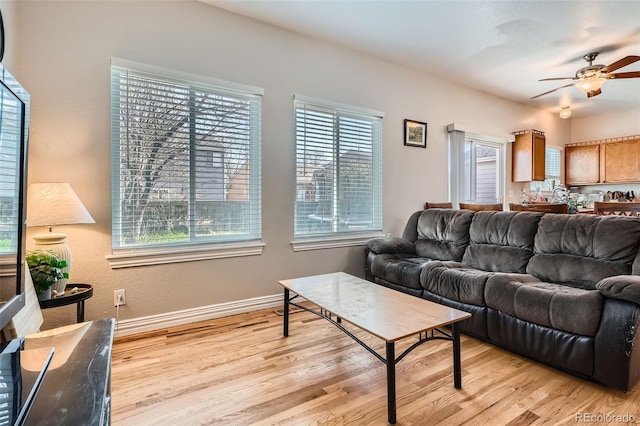 9615 Lansing Cir, Commerce City, CO 80022 - living room with ceiling fan, baseboards, light wood-style floors, and plenty of natural light