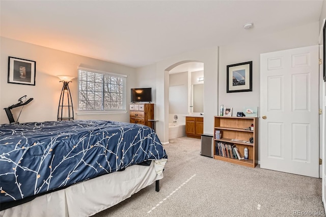 9615 Lansing Cir, Commerce City, CO 80022 - bedroom with ensuite bath, arched walkways, and carpet floors