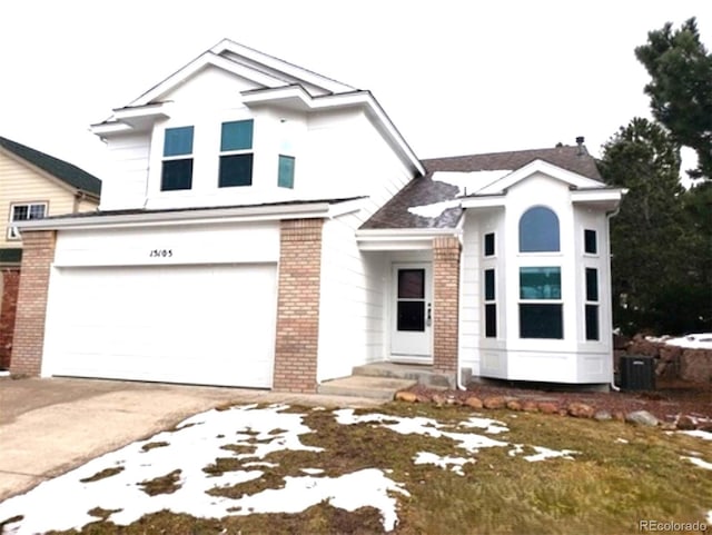 view of front of property with brick siding, driveway, and an attached garage