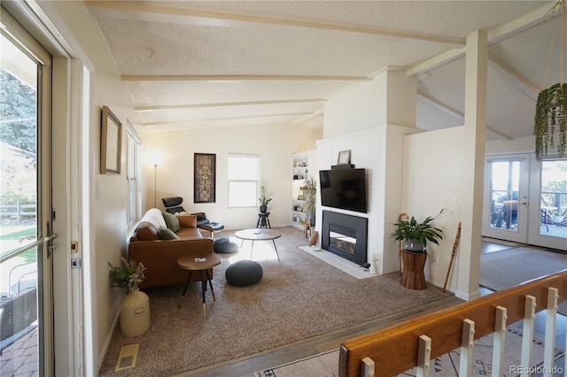 carpeted living room with a textured ceiling, plenty of natural light, lofted ceiling with beams, and french doors