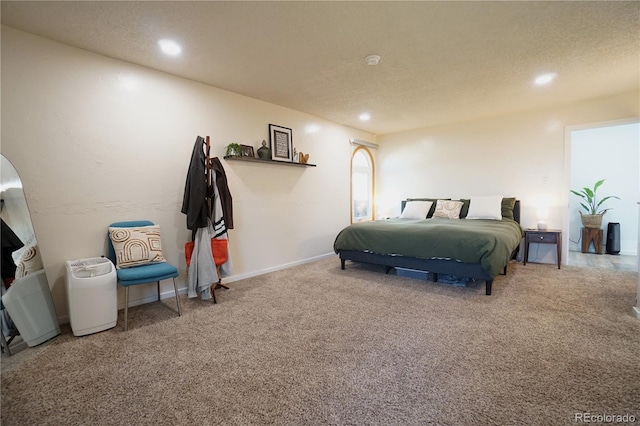 bedroom with carpet and a textured ceiling