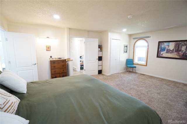 carpeted bedroom featuring a textured ceiling