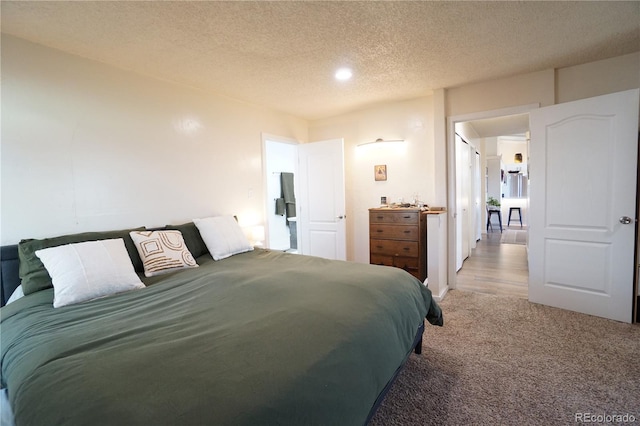 bedroom featuring carpet and a textured ceiling