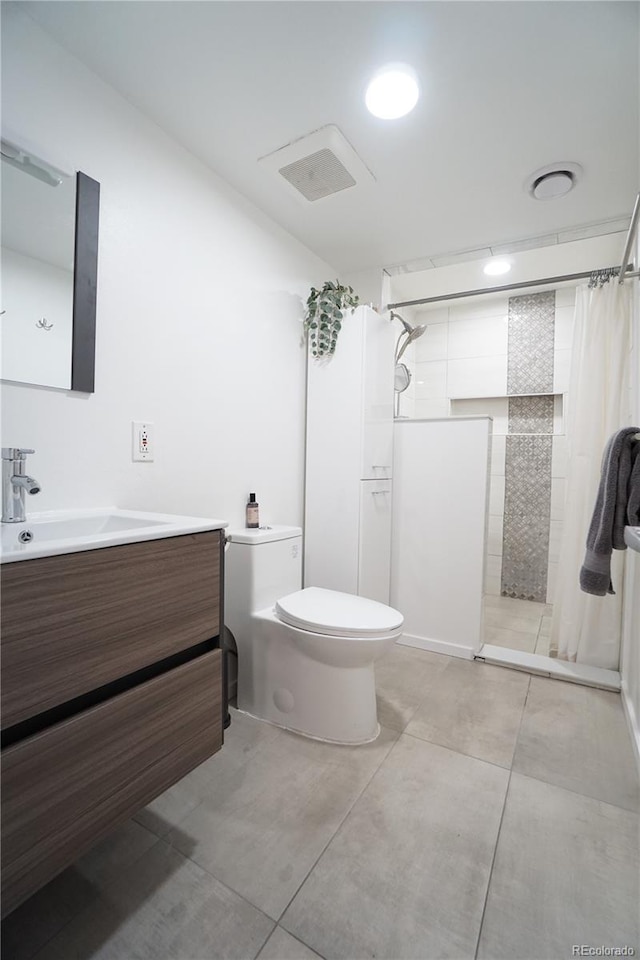 bathroom featuring a shower with shower curtain, tile patterned floors, vanity, and toilet