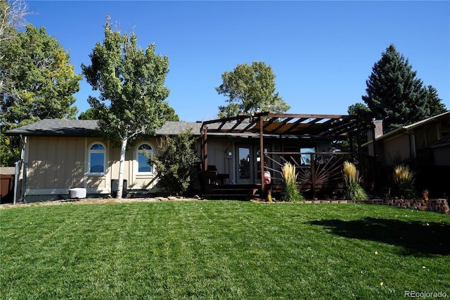 back of property with a pergola and a yard